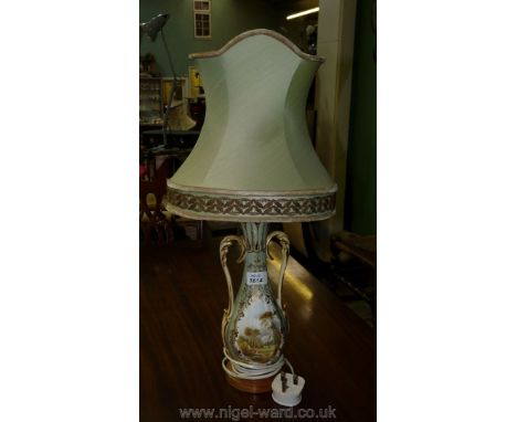 A pottery table lamp with a hand painted scene of a country house and colourful flowers to rear panel.