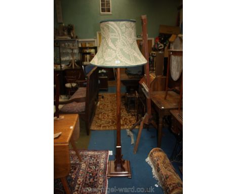 A dark stained wood Standard Lamp with green fabric shade