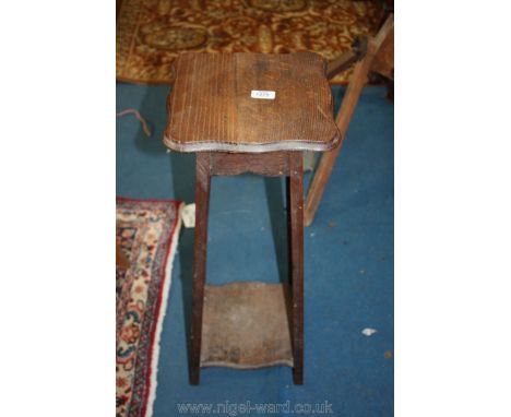 A shaped top Oak 1920/30's Plant/Lamp Table having a lower shelf, the top 10 3/4'' x 10 3/4'', 28 1/4'' high