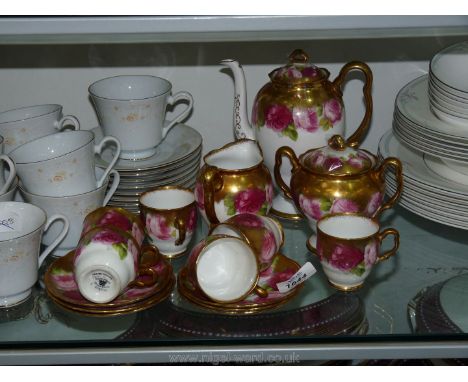 A gilded Royal Albert 'Old English Rose' Coffee set comprising six cups and saucers, milk jug and coffee pot.