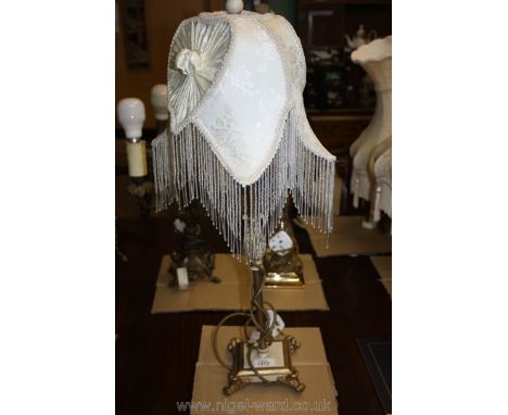 A late 20th c. ornate and slender Lamp with beaded shade