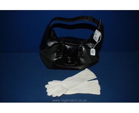 A black Mulberry Bag and a pair of white vintage Gloves