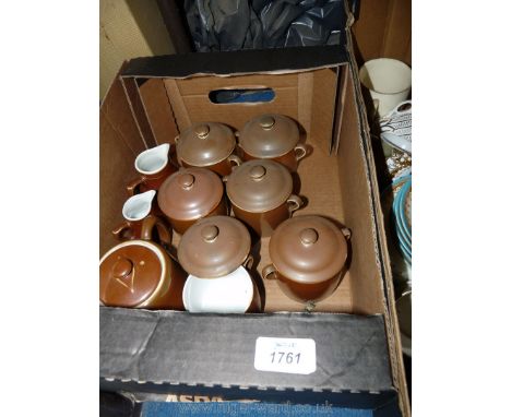 Six two-handled Royal Worcester chocolate cups and a Royal Worcester teapot and two cream jugs in brown.