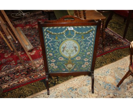 An Oak framed Firescreen with tapestry panel illustrating trailing flowering foliage, birds and a fountain, 19 1/2'' wide x 3