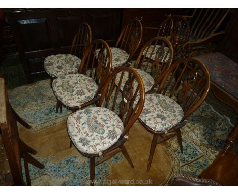 A set of seven ''Ercol'' Dining Chairs including six diners and one carver with fleur-de-lys/Prince of Wales feather detail s