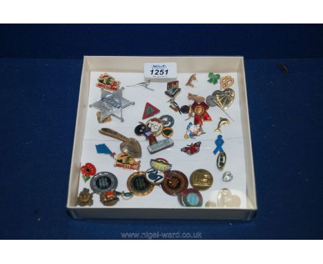 A quantity of badges (43), rare Lotus badge and a black vintage Golliwog badge.