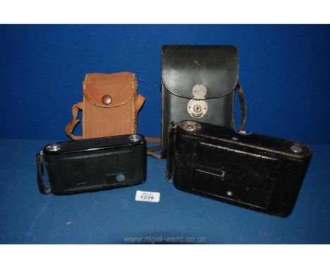 A Kodak No.3 folding camera in original case, with a Zeiss Ikon folding camera contaflex.
