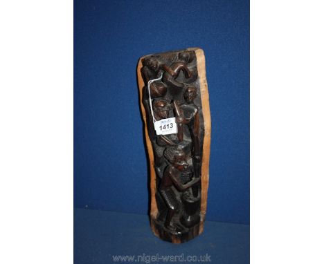 A quantity of hand carved African figures in tree trunk.