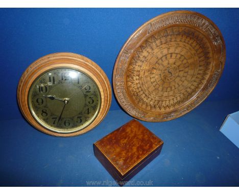 A 20th century brass faced clock, oriental wooden plate and a small burrwood box.