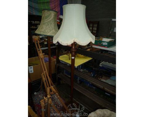 A Mahogany Standard Lamp having hexagonal column and fringed pale green shade