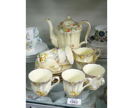 A Crown Staffordshire teapot, sugar basin, milk jug, five cups and six saucers, cream ground with floral pattern, some a/f