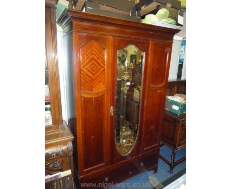 An Edwardian Mahogany Wardrobe having a central shield shaped bevelled mirror to the door, deep hat drawers to the base, with