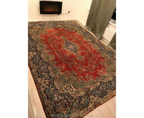 A fine hand-made red Kerman Carpet, 13'2" x 9'7", of fine wool on cotton foundation