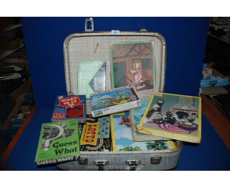 A 1950's/60's suitcase containing vintage children's nursery rhyme wooden jigsaws.