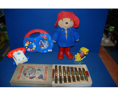 A Tremolo-phone in original box, Paddington bear, Magic Roundabout toy, a Fisher Price telephone and pull-along train.