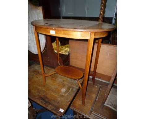 An oval Mahogany occasional Table having a lower shelf as part of the stretchers and with boxwood stringing, 28'' x 18'' x 27