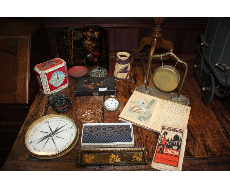 A large brass surround compass, 19th c. paper mache pen tray, table screen, small brass face mask, brass gong (lacking hammer