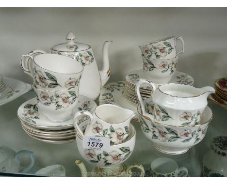 A part Teaset by Crown Staffordshire white with rose decoration including a teapot milk jug and sugar basin, cups saucers, te