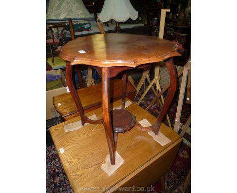 A shaped top low Mahogany occasional Table, the legs united by a stretcher and lower shelf, 23 1/2'' diameter x 25'' high