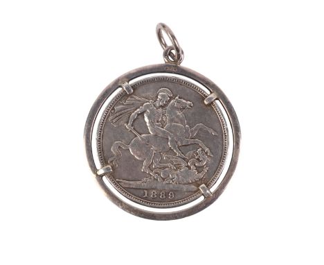 A Queen Victoria 1889 silver crown mounted in a claw set pendant.