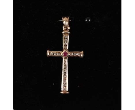 A 9ct gold cross pendant set with diamonds and a central ruby, 3.1g.