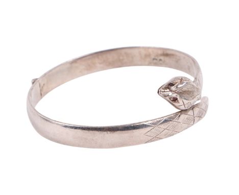 A silver hinged snake bangle with ruby set eyes, 30g.