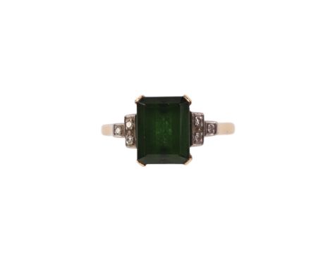 An 18ct gold ring set with a large green stone and diamond set shoulders, approx UK size K, 3.5g.