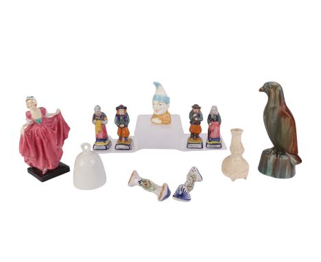A group of four Quimper figures, each 8.5cms high; together with a Royal Worcester Mr Punch candle extinguisher, 9cms high; a