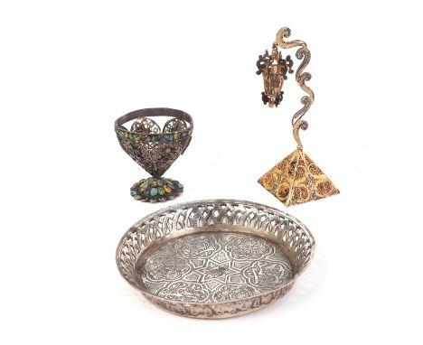 A small Persian white metal dish with pierced rim, 10cms diameter; together with a Turkish filigree silver and enamel cup, 4.