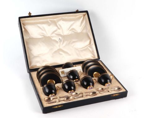 A Royal Worcester black matt and gilt Greek Key design cased six-piece coffee cup and saucer set with six silver spoons.Condi