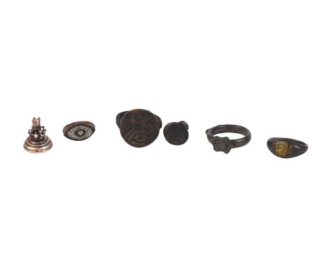 A patinated bronze ring seal; together with others similar (6).