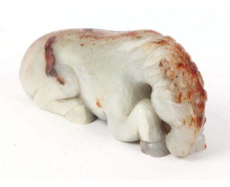 A Chinese figured jade carving in the form of a recumbent horse, 7.5cms long