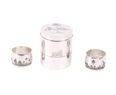 An Iraqi silver tea caddy with engraved decoration and a similar pair of niello napkin rings (all test as silver), 187g.