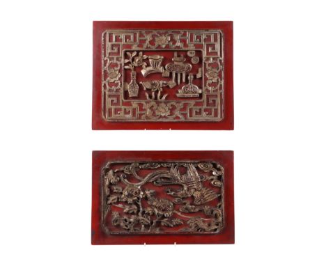 A Chinese carved giltwood panel decorated with precious objects, on a red ground, 46 by 36cms; together with another similar 