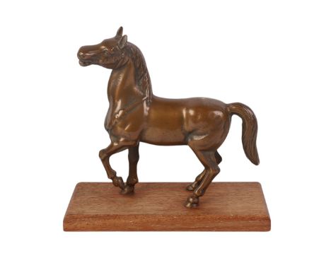 A cast bronze model of a horse on a wooden plinth, 16cms long.