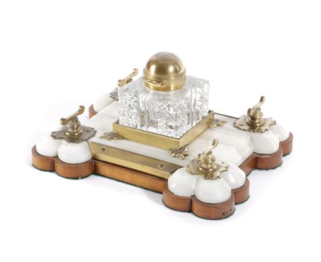 A Victorian onyx, brass and satinwood partner's desk stand by Betjemann & Son, dated 1896, the glass inkwell engraved with in