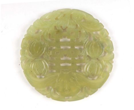 A Chinese jade / hardstone pierced disc, the carved decoration depicting peaches, 8cms diameter.