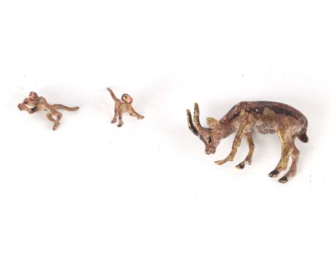 A miniature Vienna cold painted bronze antelope, 4cms long; together with two tiny Vienna cold painted bronze monkeys, each 1