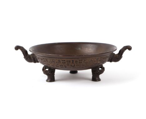A Chinese bronze tripod censer with Taotie mask feet and elephant mask handles, six character mark to the underside, 20cms di