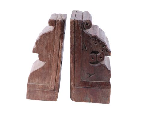 Two similar carved hardwood bookends made from the terminals of architectural pillar caps, 12 by 12 by 26cms high (2).