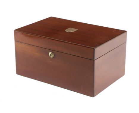 An early 20th century mahogany humidor by Alfred Dunhill, the hinged cover with an engraved shield-shaped crest enclosing an 