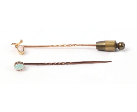 A 15ct gold opal set stick pin, 0.9g; together with another similar (2).