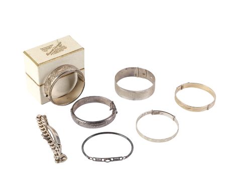 A group of silver bangles and bracelets to include a finely engraved example, 164g.