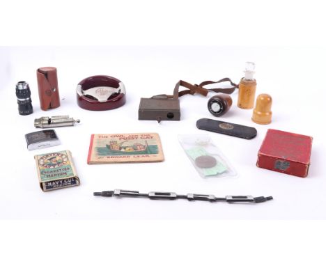An MG ashtray; together with a Cortina gear stick knob; a treen bottle holder and other items.
