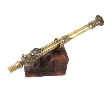 A 19th century South East Asia bronze portable swivel Lantaka cannon mounted on a hardwood block base, the cannon barrel 44cm