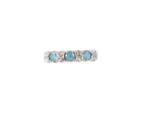 A 9ct gold ring set with three pale blue stones and four diamonds, approx UK size K, 2.2g.