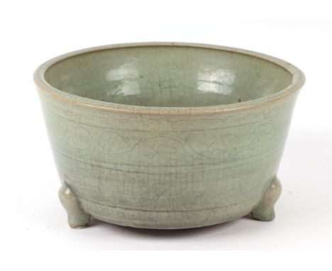 A Chinese crackleware celadon glaze and planter on three legs, with incised decoration to the body, 25cms diameter.Condition 
