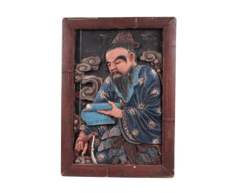 A Japanese Meiji period relief carved and polychrome painted picture panel depicting a scholar with inset glass eyes, in a fa