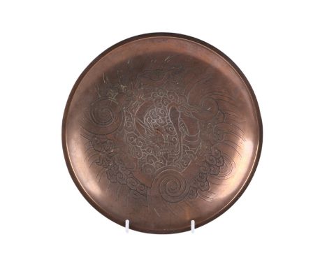 A Chinese bronze dish with inlaid wire decoration depicting a dragon, 24cms diameter.