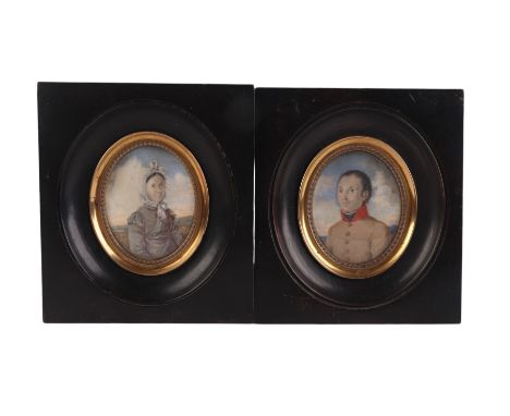 A pair of 19th century continental portrait miniatures on ivory depicting a husband and wife, glazed and in ebonised frames, 